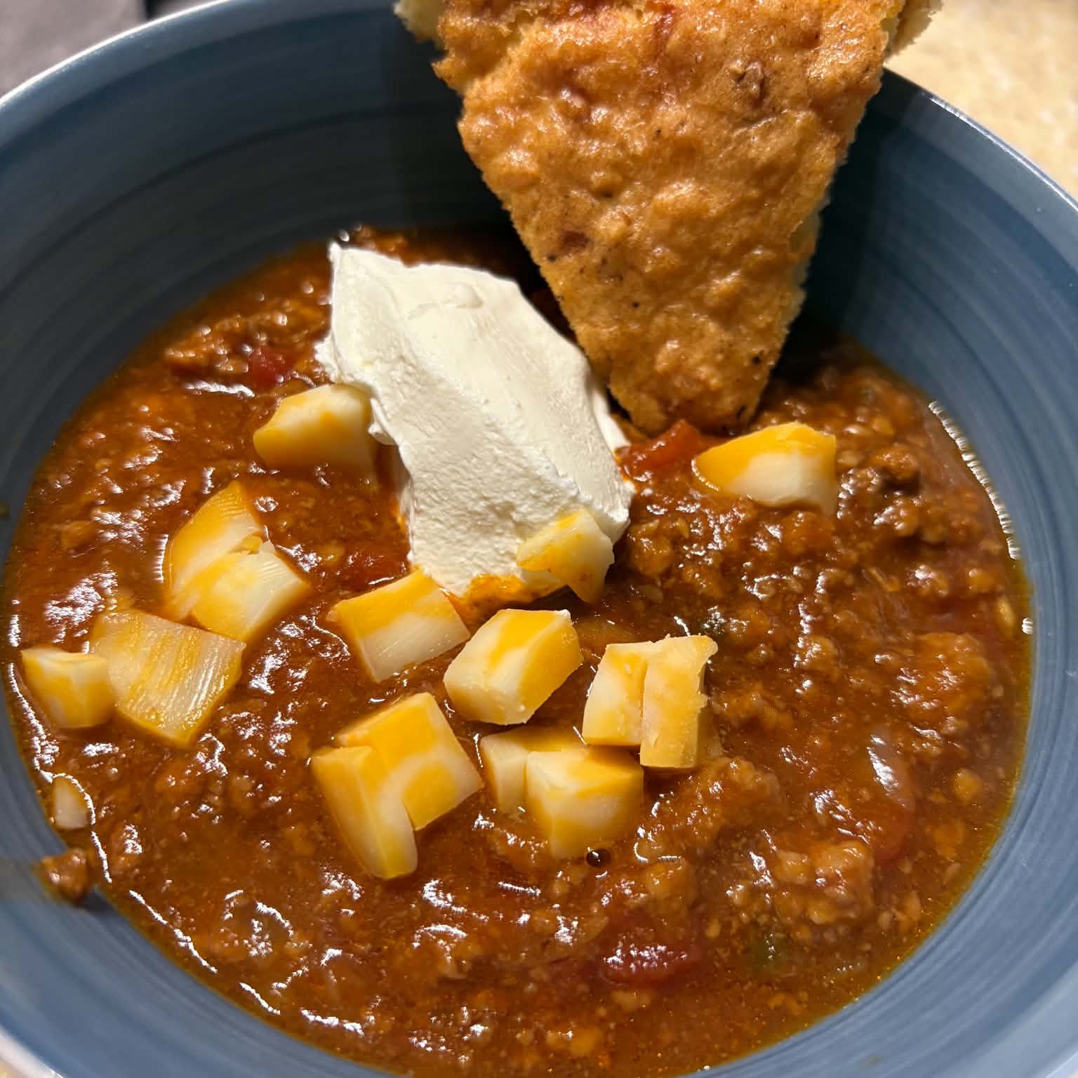 No bean chili, served with cubed cheese, sour cream, and mock cornbread
